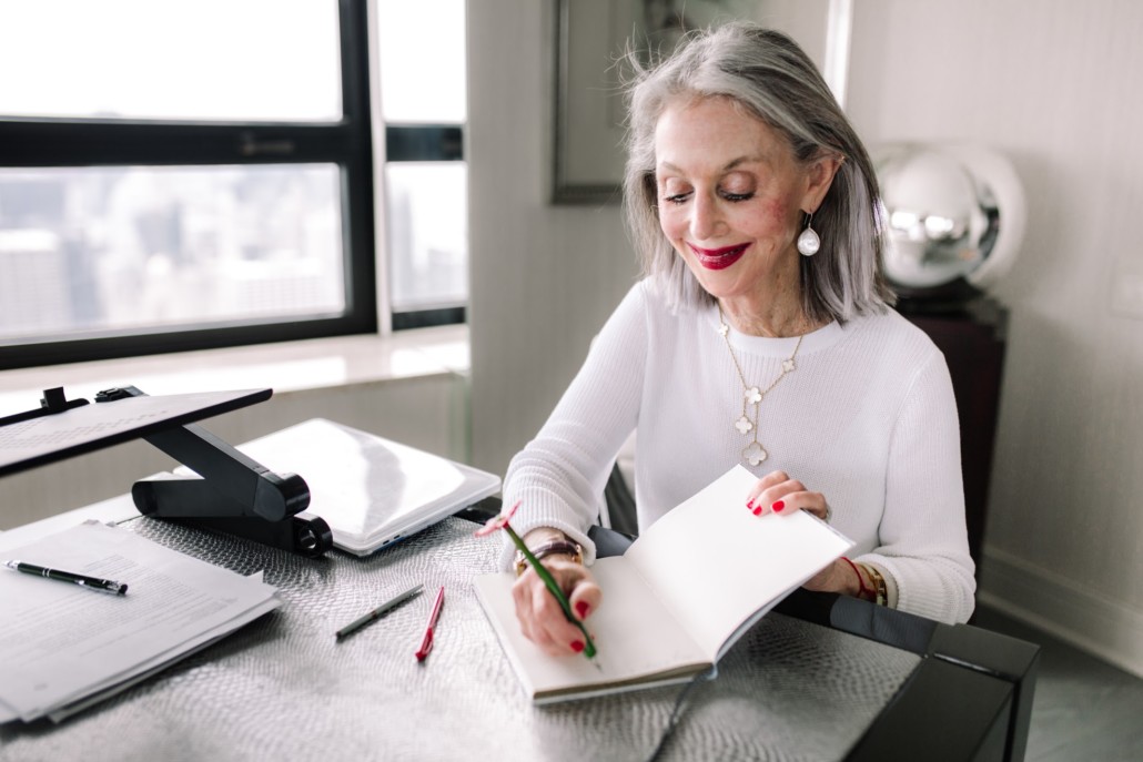 Honey Good at her table making notes in her journal to enlarge her world with awe and ward off loneliness.