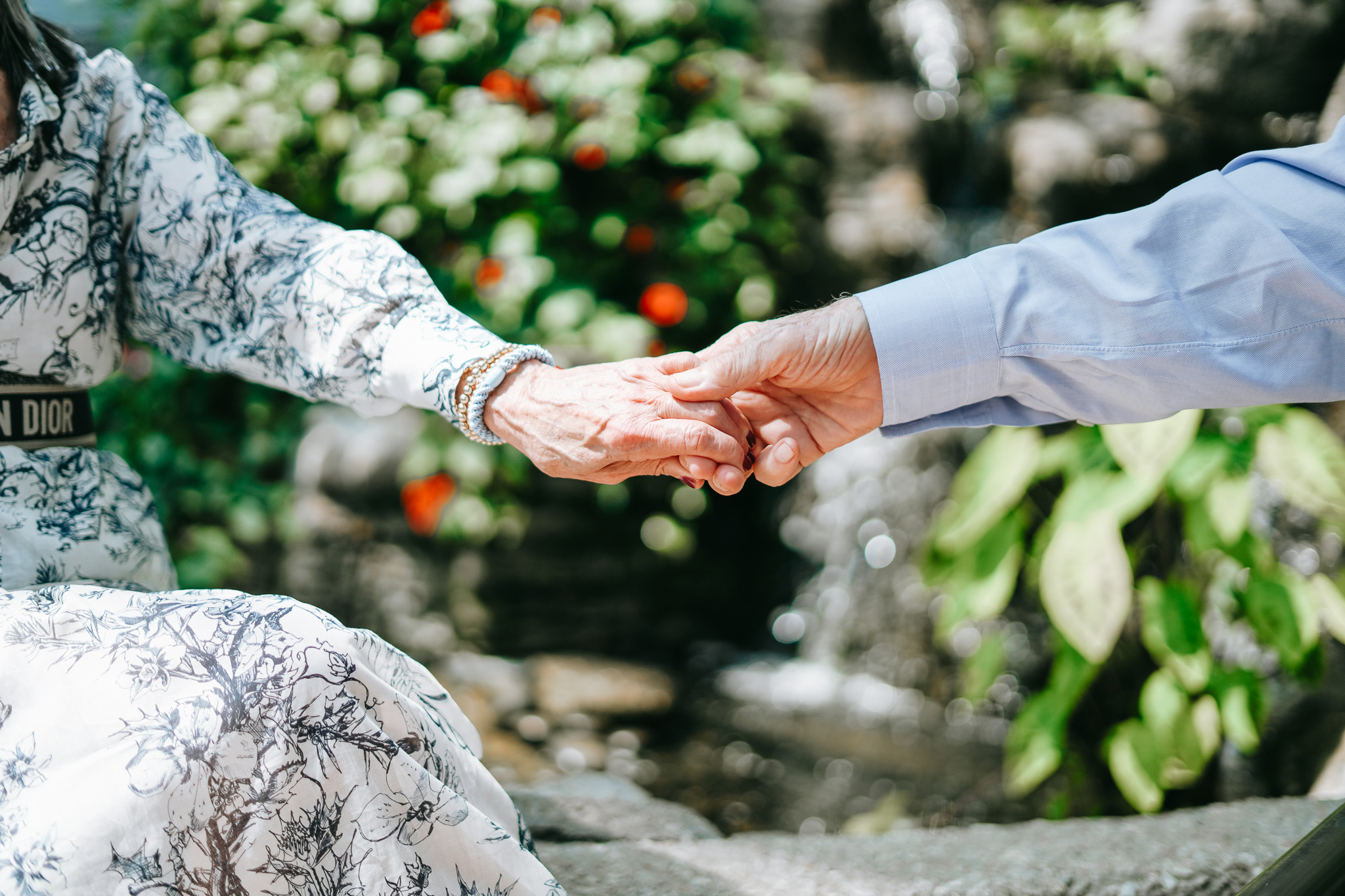 holding hands in a garden showing the importance of caring for yourself when you are a caregiver and caretaker