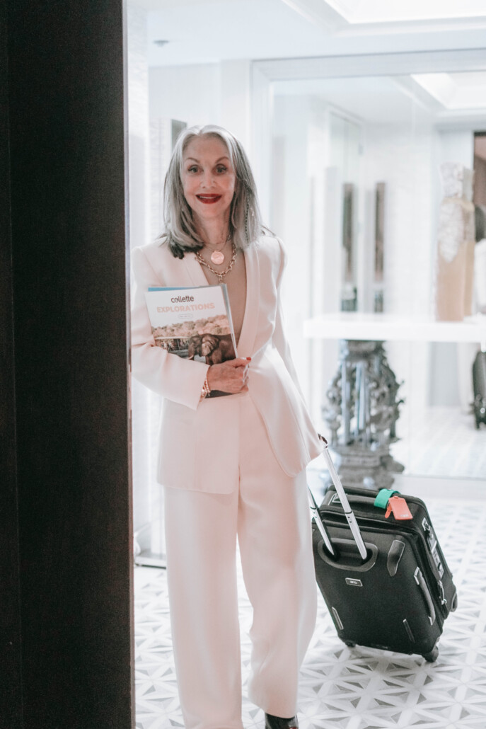 modern grandmother honey good with suitcase and white suit