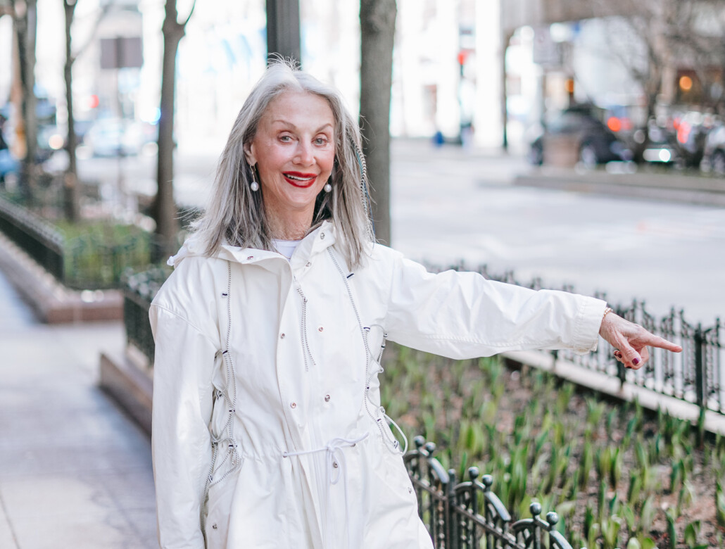 honey good natural beauty in white coat pointing