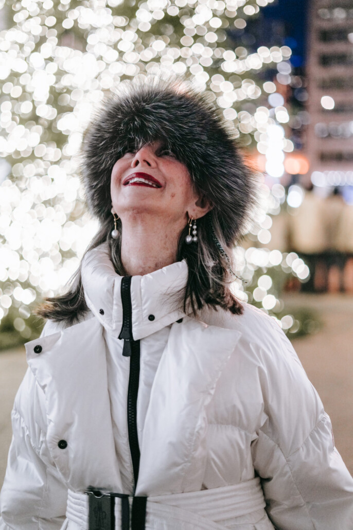 jewish girls christmas honey good standing in front of christmas tree smiling